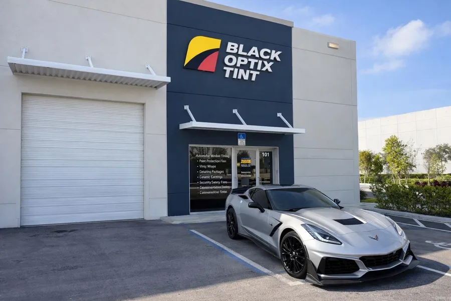 Silver Corvette parked outside Black Optix Tint Doral