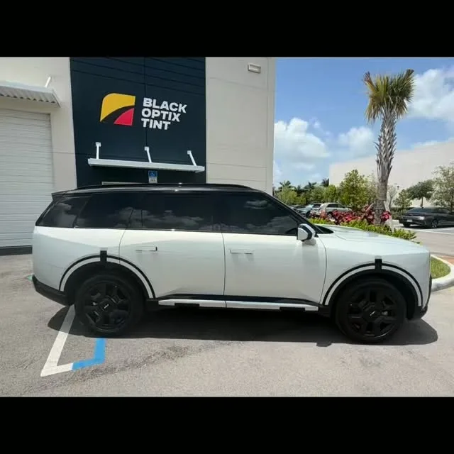 Kia Telluride with tuxedo wrap and ceramic tint outside the Doral shop